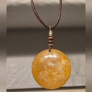 Stone-like resin pendant with rope necklace.